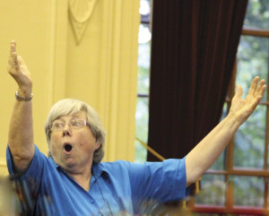 The inimitable Judy Clingan conducts the massed antiphonal choirs in Hassler